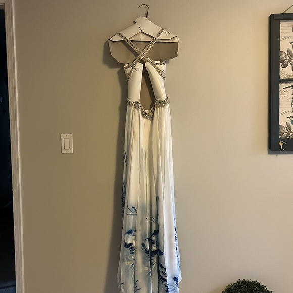 A Jasz Couture Beautiful white with blue florals formal dress with cut outs. - Picture 6 of 10